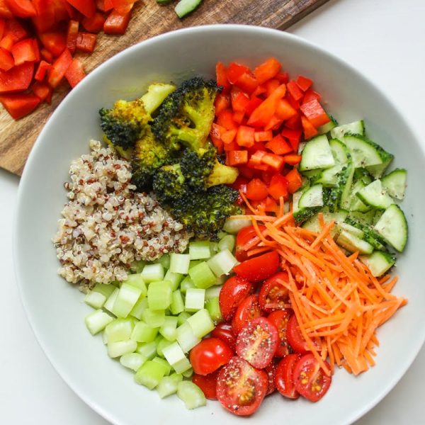 A vibrant bowl of fresh vegetables and quinoa, perfect for a healthy meal.